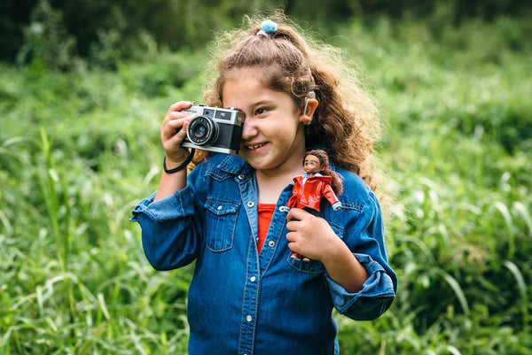 child holding a lottie doll