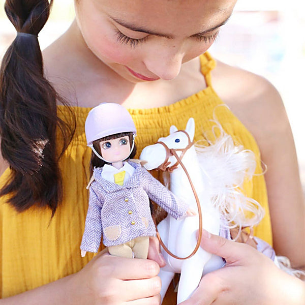 Girl holding Lottie Doll with White Pony