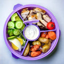 Purple bowl with 4 compartments with food and 1 center compartment to hold sauce, dressing, etc