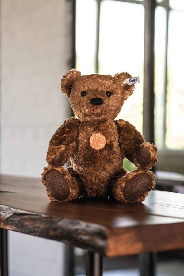 Brown teddy sitting on a table