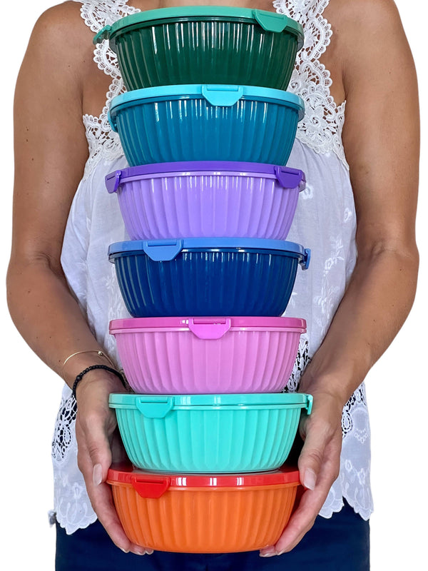 woman holding 8 different color bowls. 