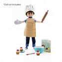 Doll wearing Doll apron, mixing bowl, chef hat, mitt, rolling pin, spoon, cupcakes and recipe book
