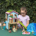 Girl playing with lottie dolls and Blue doll treehouse with porch, green slide, Swing, and rope ladder