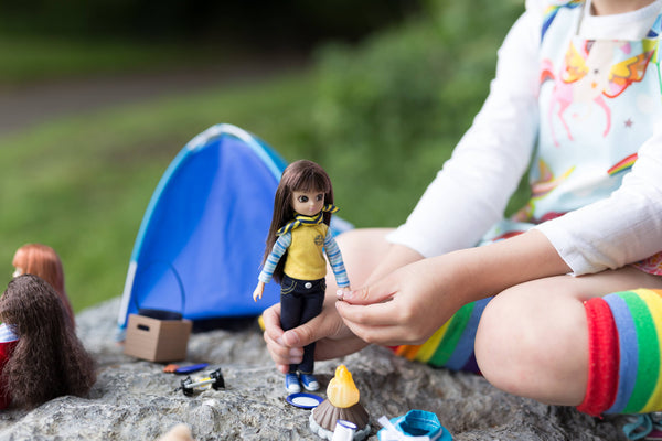 Girl playing with lottie doll