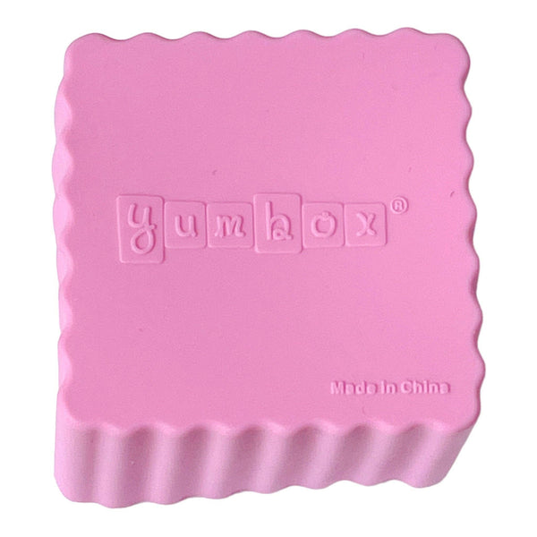 Bottom of pink square cup that says Yumbox