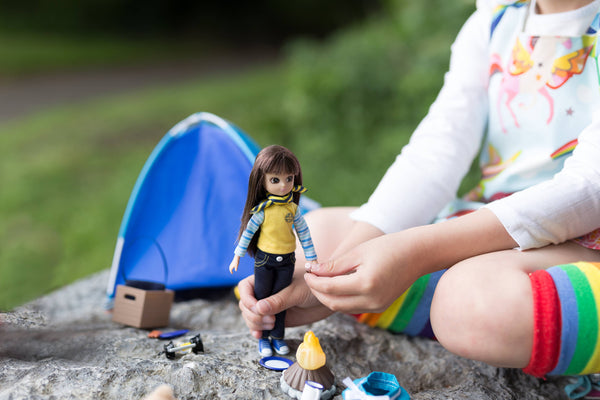 Girl playing with lottie doll