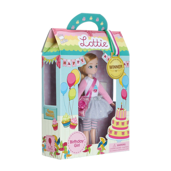 doll is dressed in a cupcake-print t-shirt, silver tutu, grey and pink leggings, silver trainers, and carries a sparkly deep pink bag. She also comes with 3 mini cards: an invitation, birthday, and thank you card.