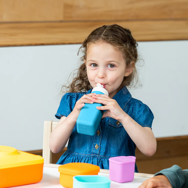 Girl drinking out of blue water bottle