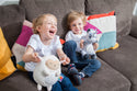 Children playing with White Lamb with star and moon projection lights on tummy.