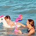 Mom and child swimming in water with their lottie doll