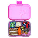 Pink yumbox with food and 2 square cups holding peas and humus