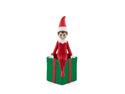 tonies elf on the shelf sitting on a green present