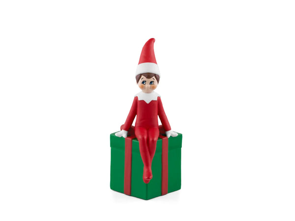 tonies elf on the shelf sitting on a green present